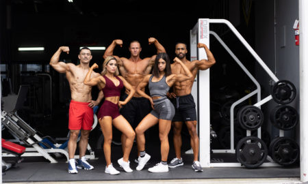 Fitness team made up of mena and women flexing